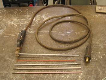 File:Arc welding electrodes and electrode holder.triddle.jpg